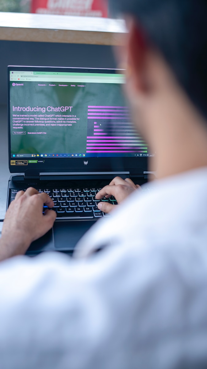 a man sitting in front of a laptop computer