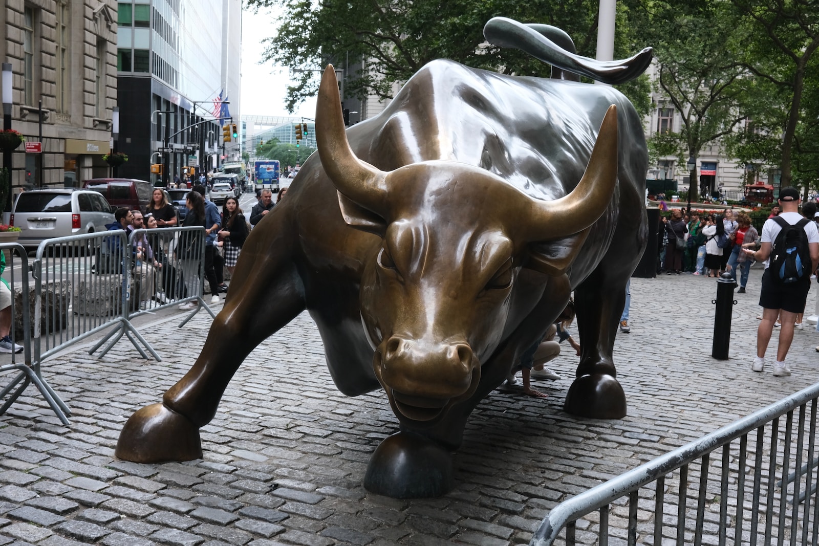 a statue of a bull on a brick street