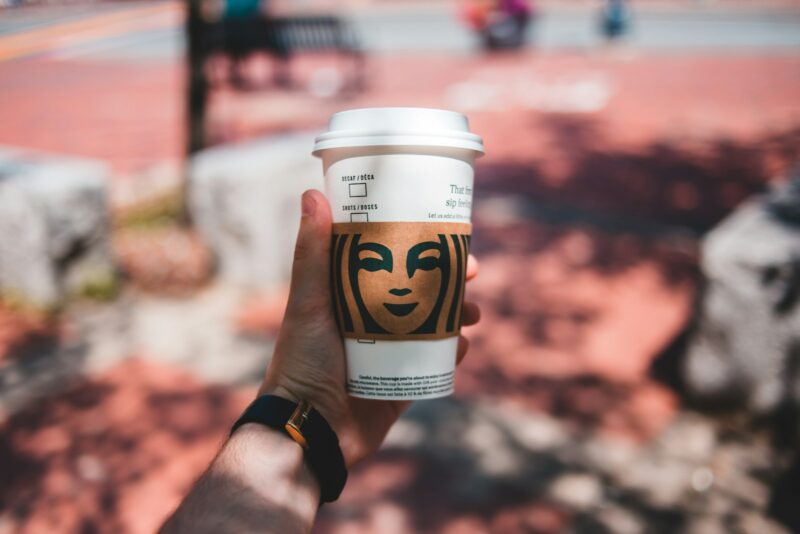 person holding disposable cup