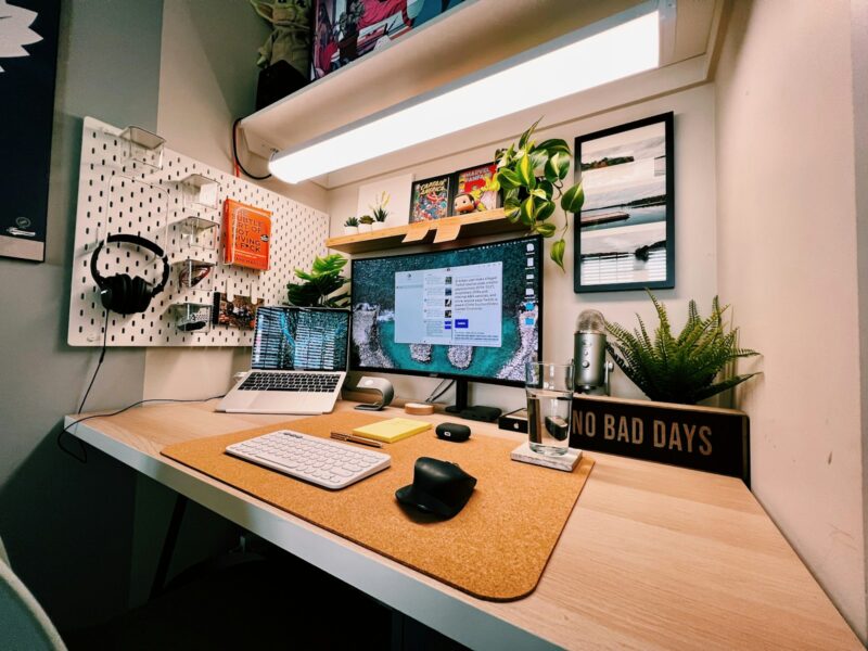 a desk with a laptop and a monitor on it